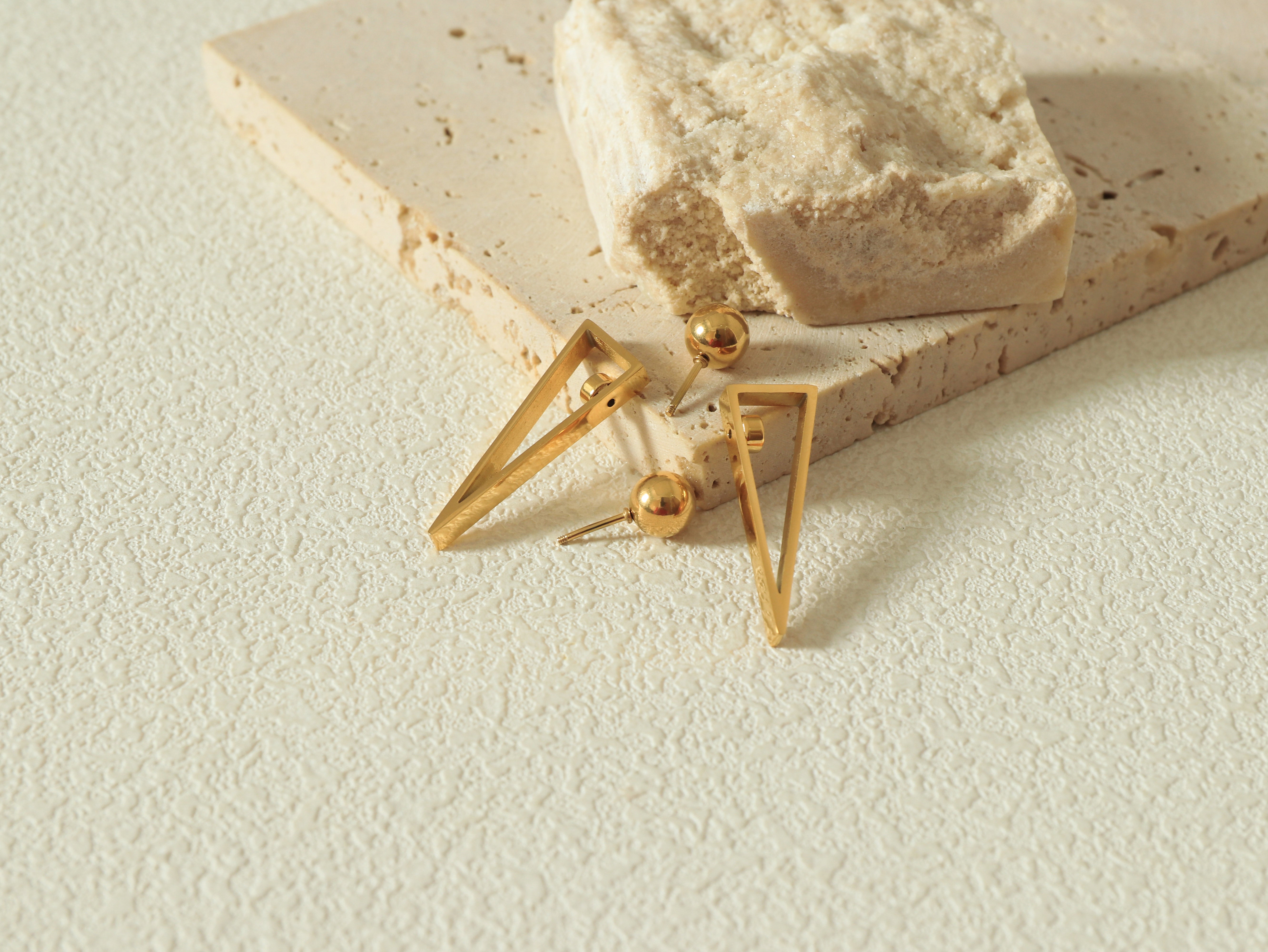 Equinox Earring in 14k real gold on stainless steel featuring Divé’s Signature Revolve Closure and geometric shape - Flat Lay Image 1