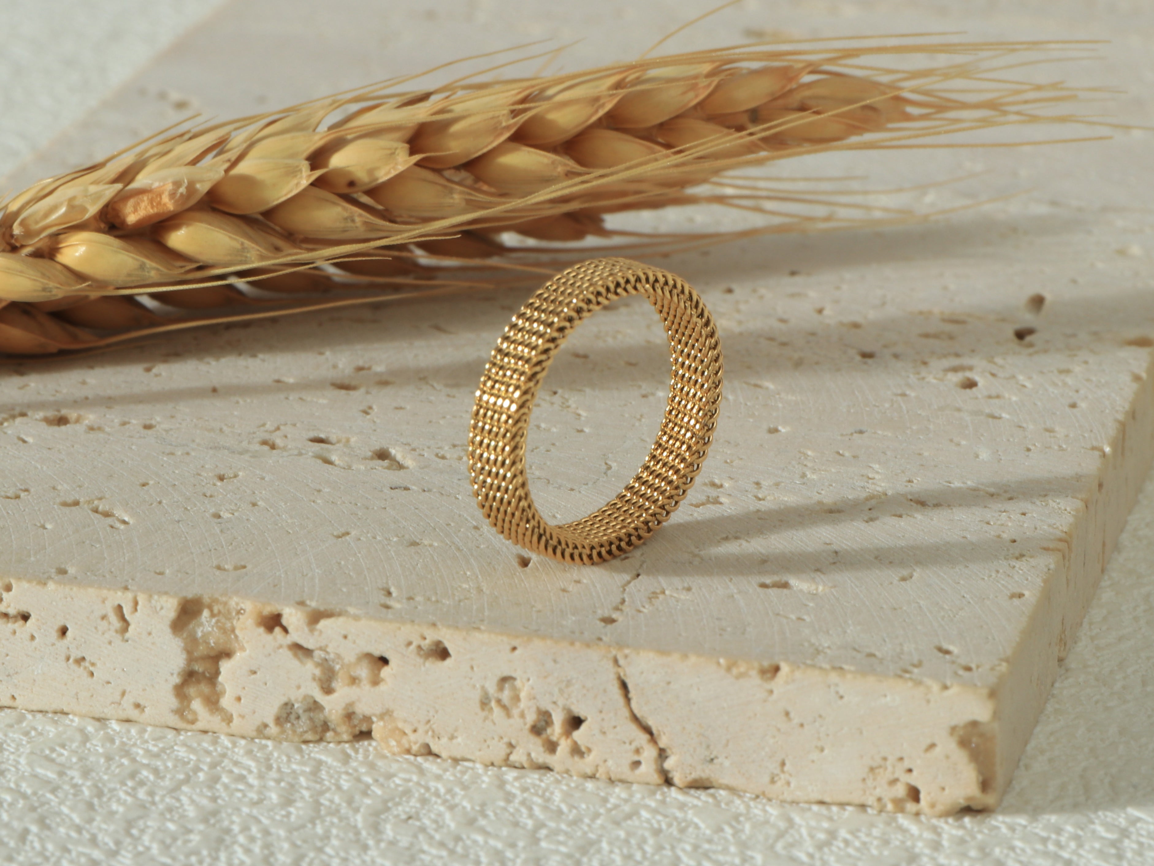 Side view of the Dominion Band in gold, standing upright, showcasing its sleek 18k gold finish and hypoallergenic, scratch-resistant design - Image 2