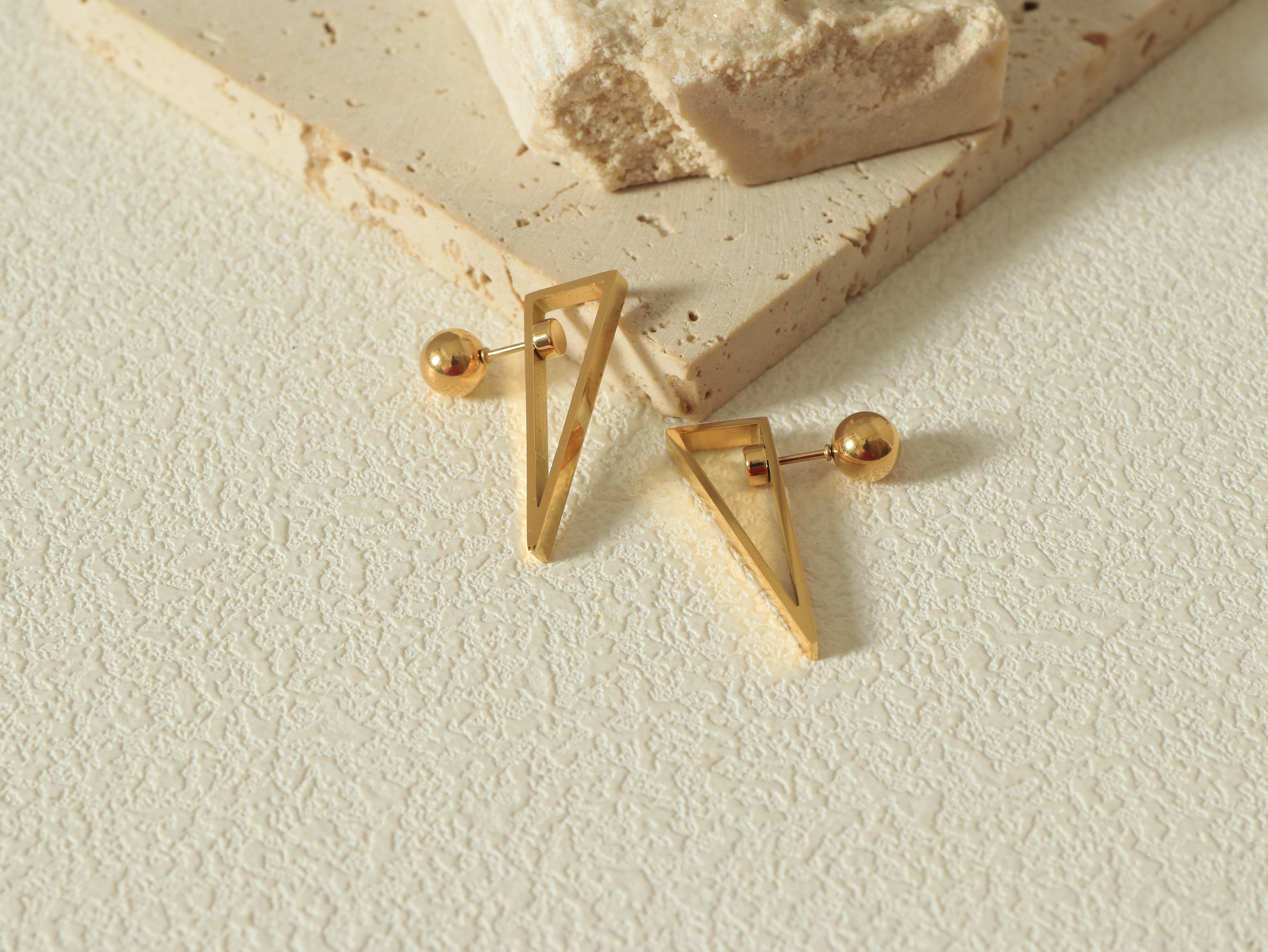 Equinox Earring in 14k real gold on stainless steel featuring Divé’s Signature Revolve Closure and geometric shape - Flat lay Image 2