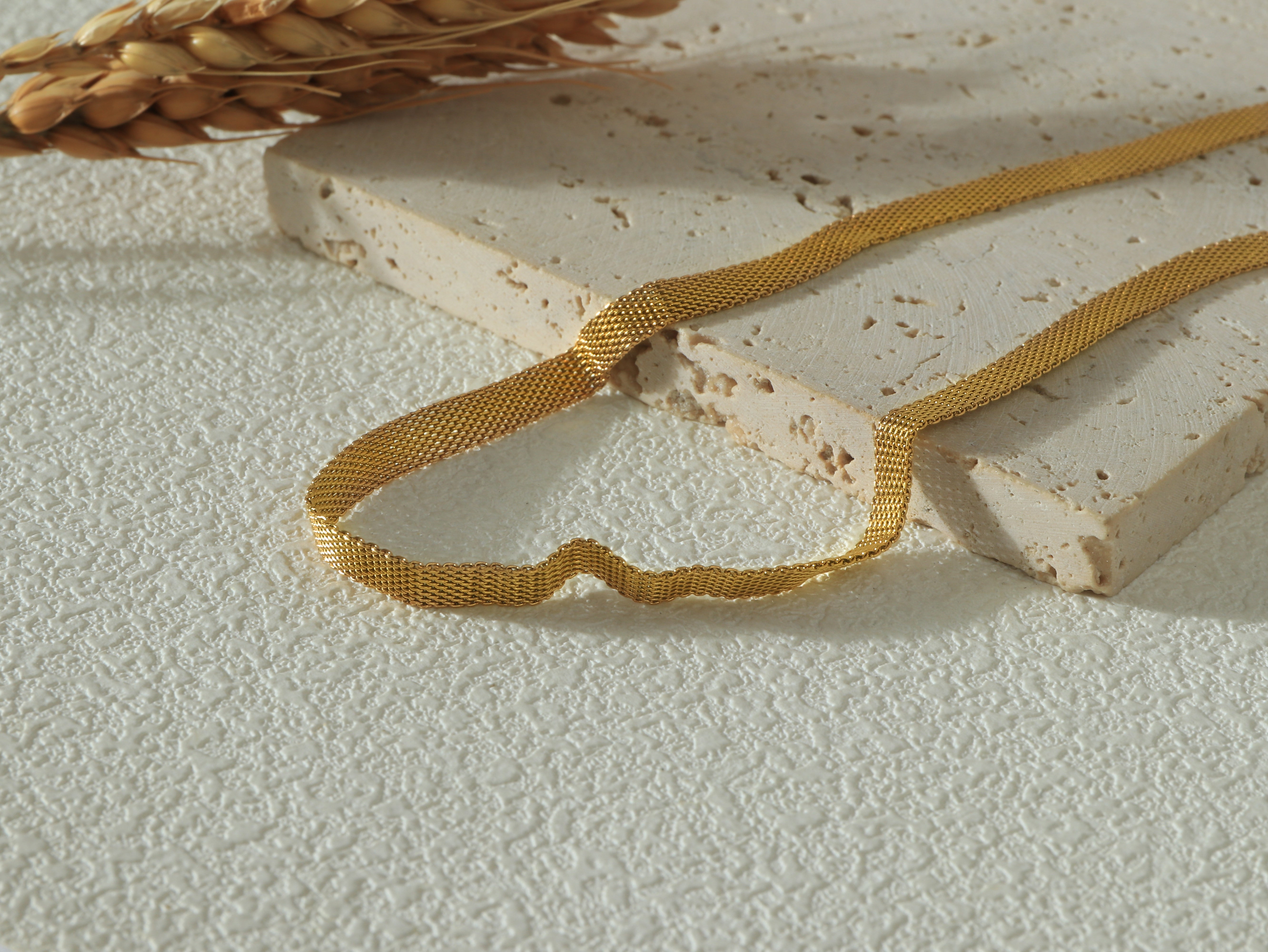 Close-up of the Dominion Necklace links, emphasizing the polished 14k gold finish and scratch-resistant texture.
