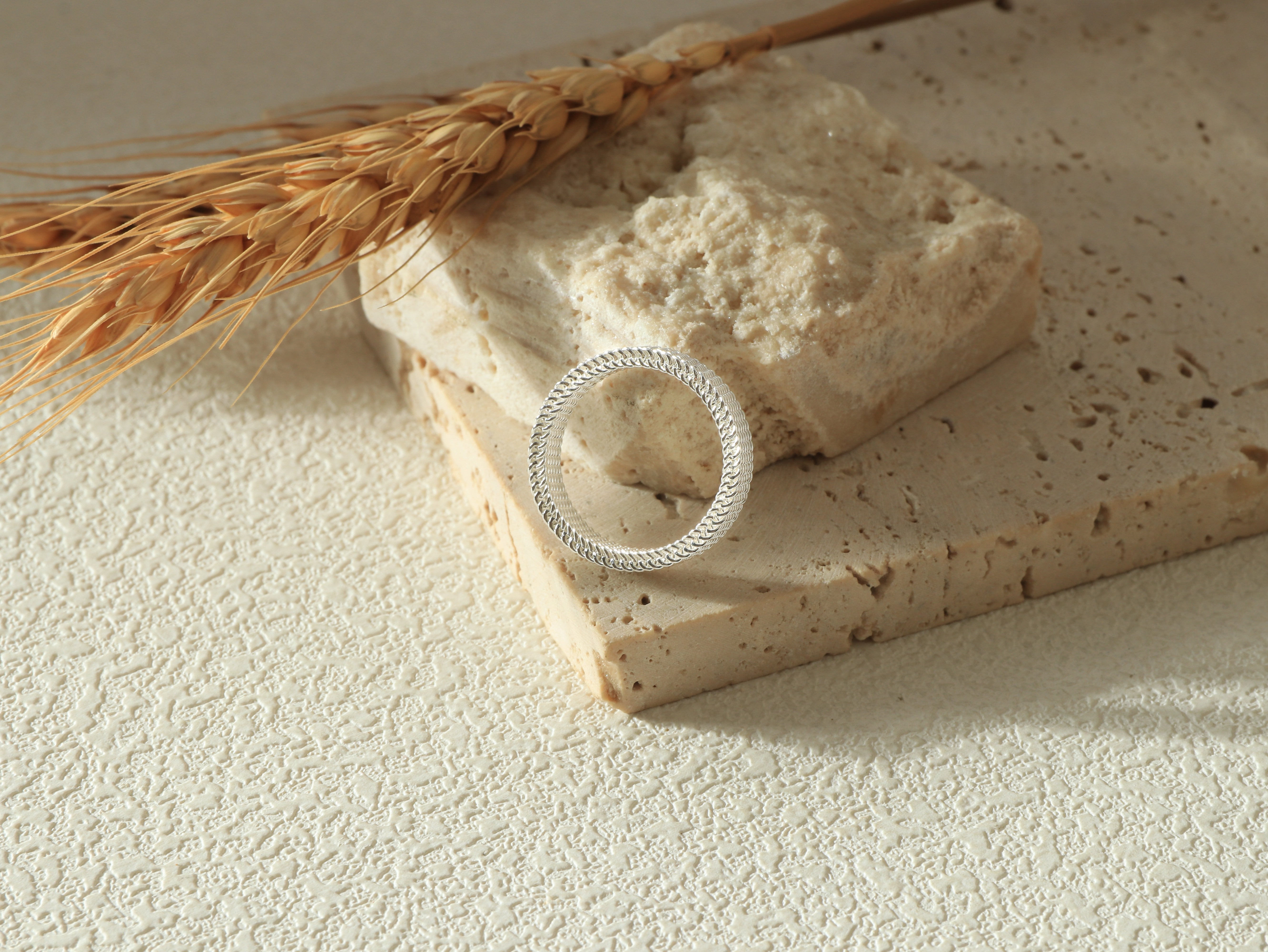Front view of the Dominion Band in silver, standing on its base, emphasizing the sleek 925 sterling silver coating and minimalist, modern design.