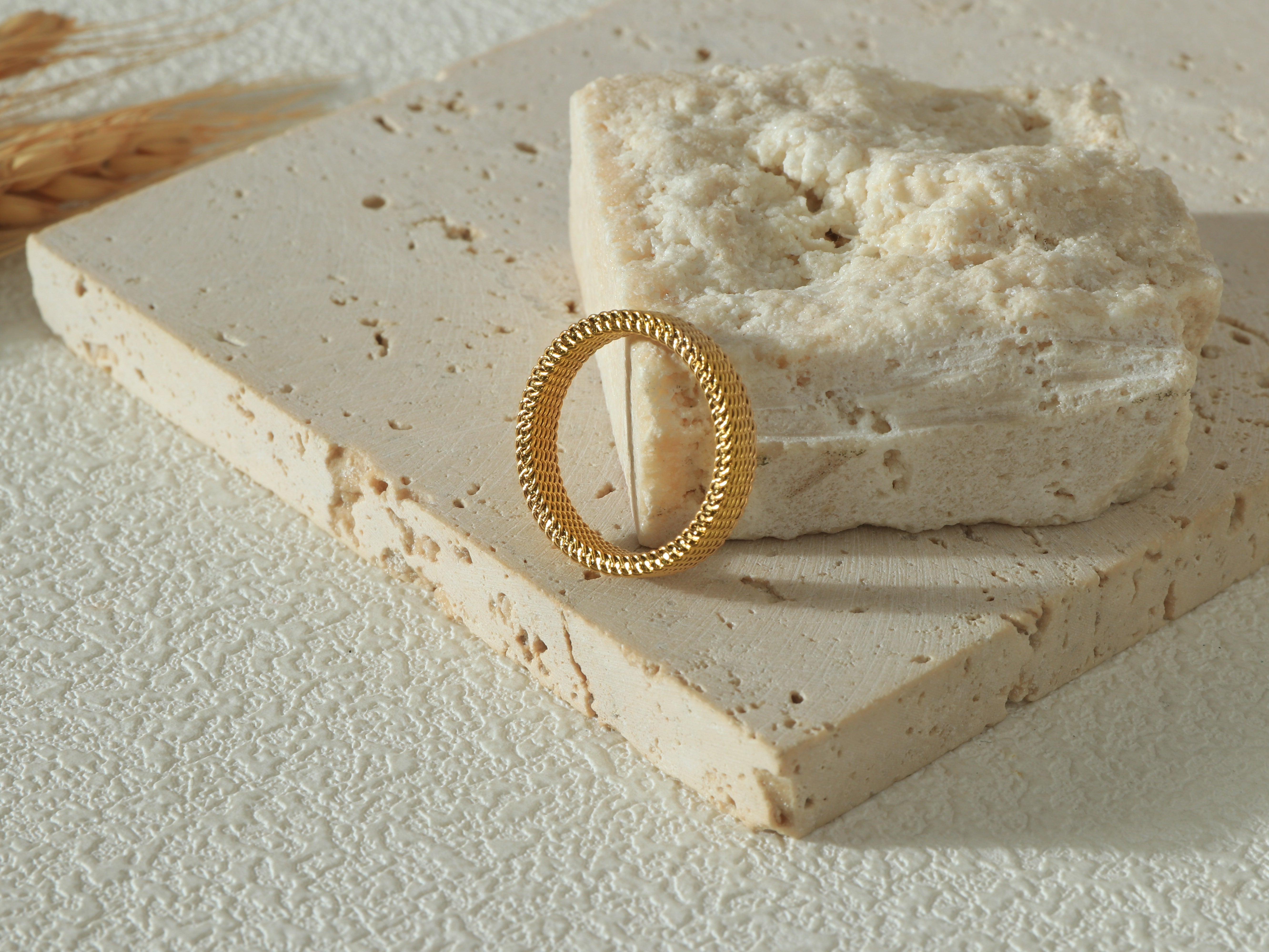 Dominion Band in gold, standing tall to display its minimalist design, 18k real gold coating, and stainless steel base.
