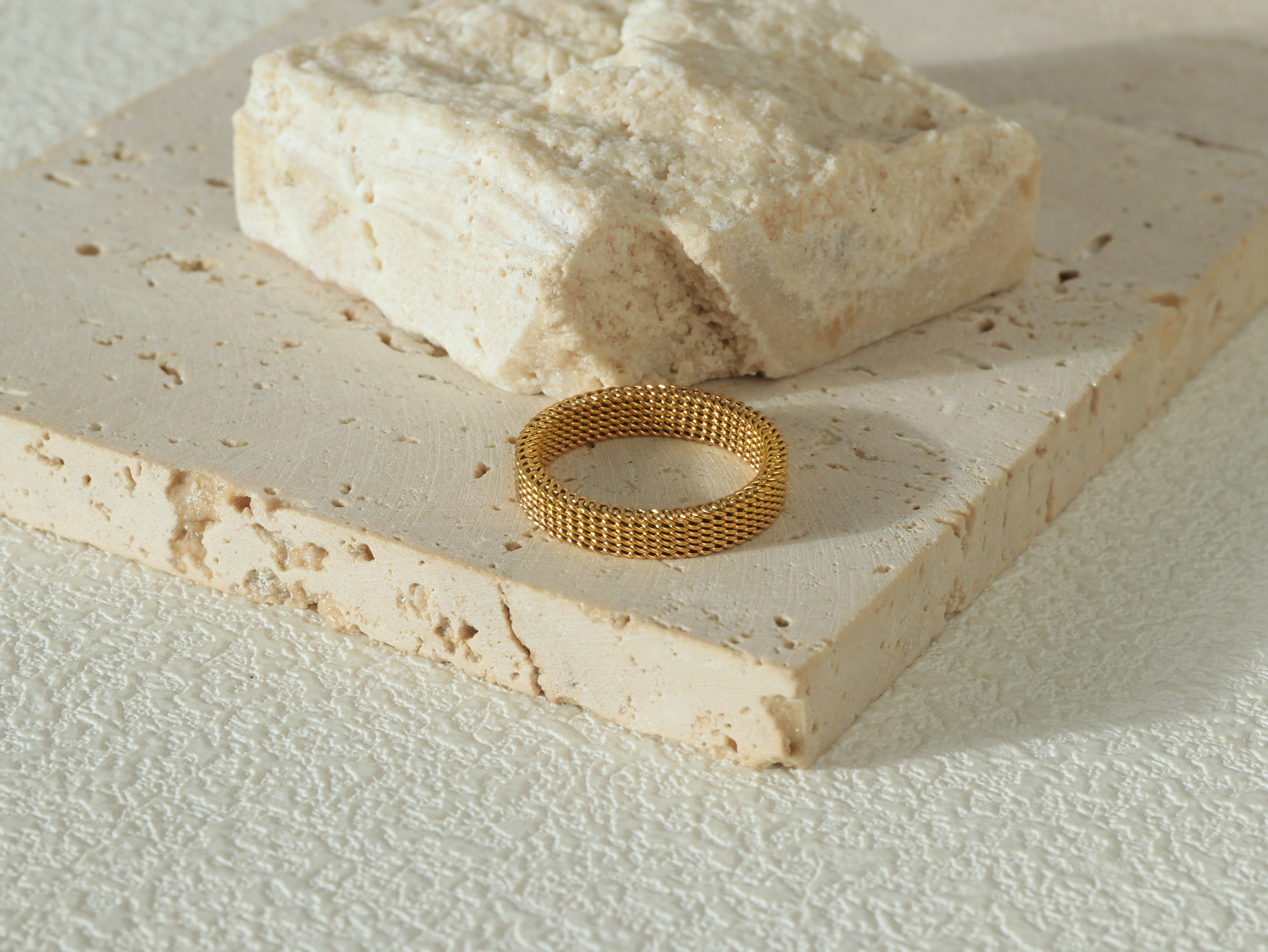 Top view of the Dominion Band in gold, laid flat, highlighting its 18k gold surface and durable, waterproof properties.