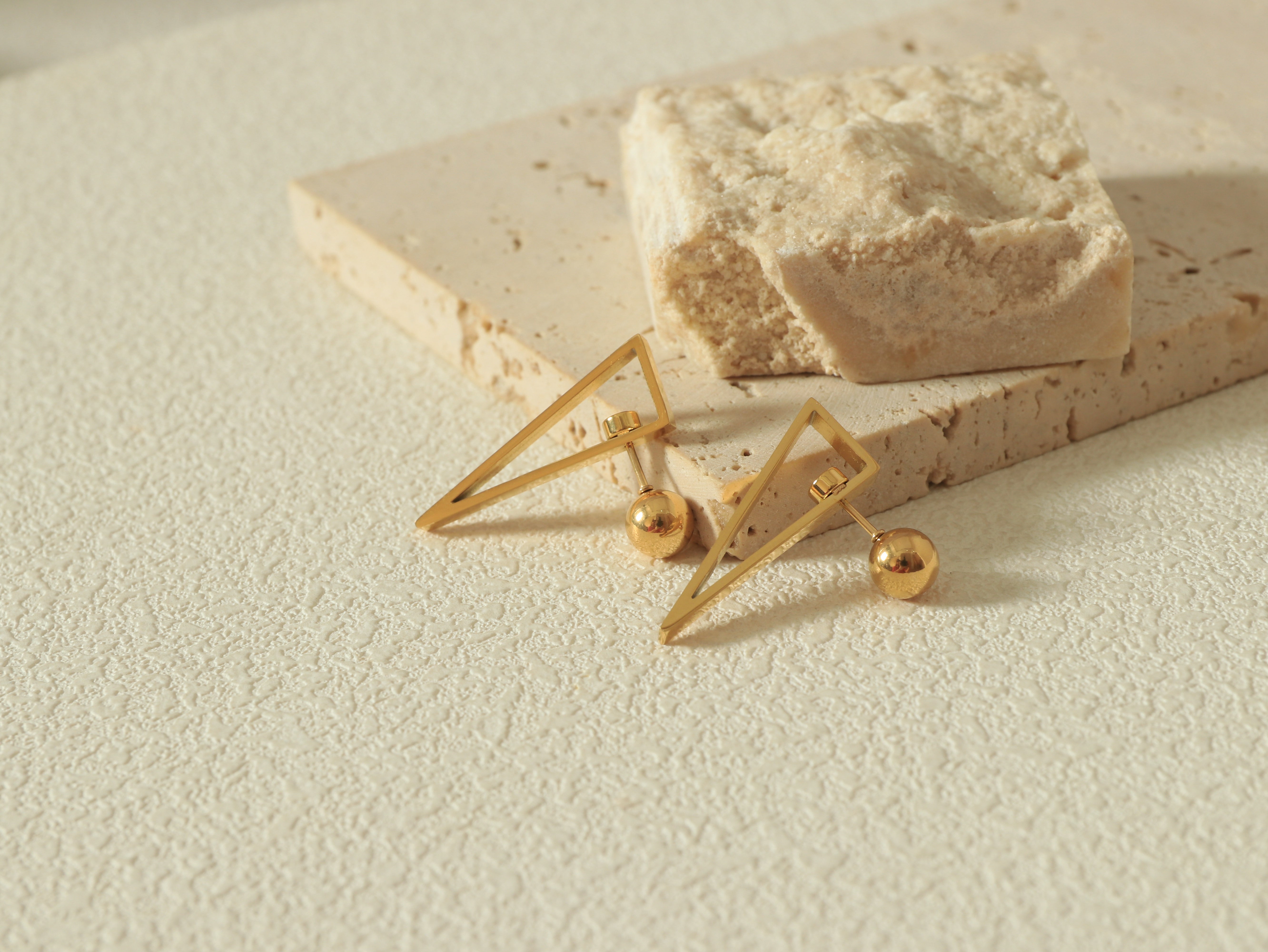Equinox Gold Earrings with the Revolve Closure mechanism and scratch-resistant 14k gold surface - Styled Flat Lay 2