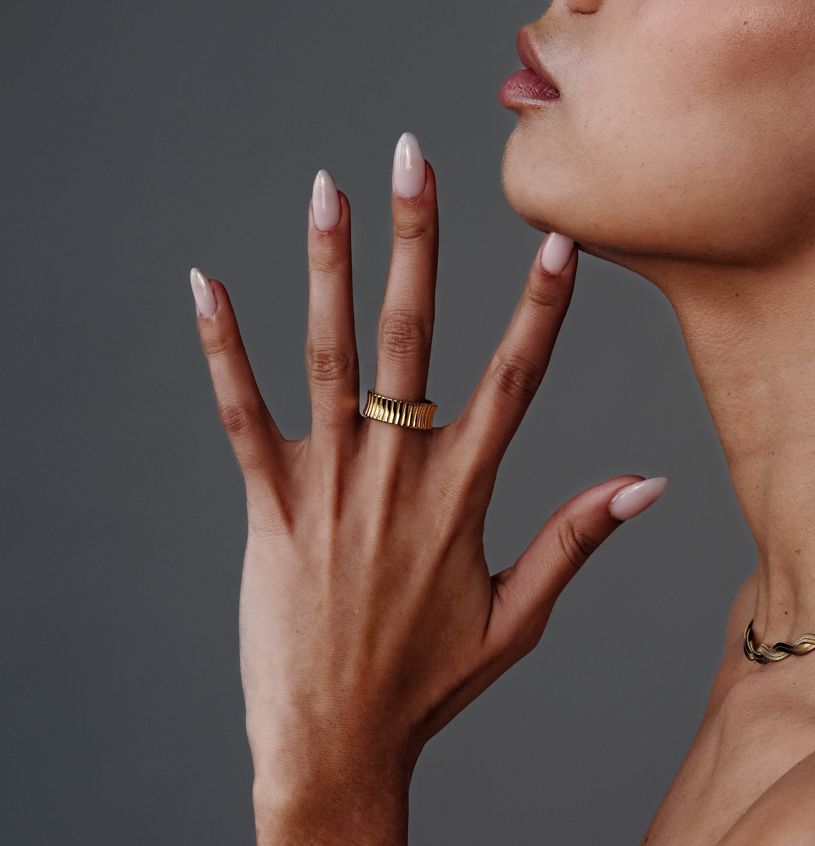 Close-up of the Gold Cleo Ring on model's hand, showing the scratch-resistant 14k gold shine and sleek silhouette.