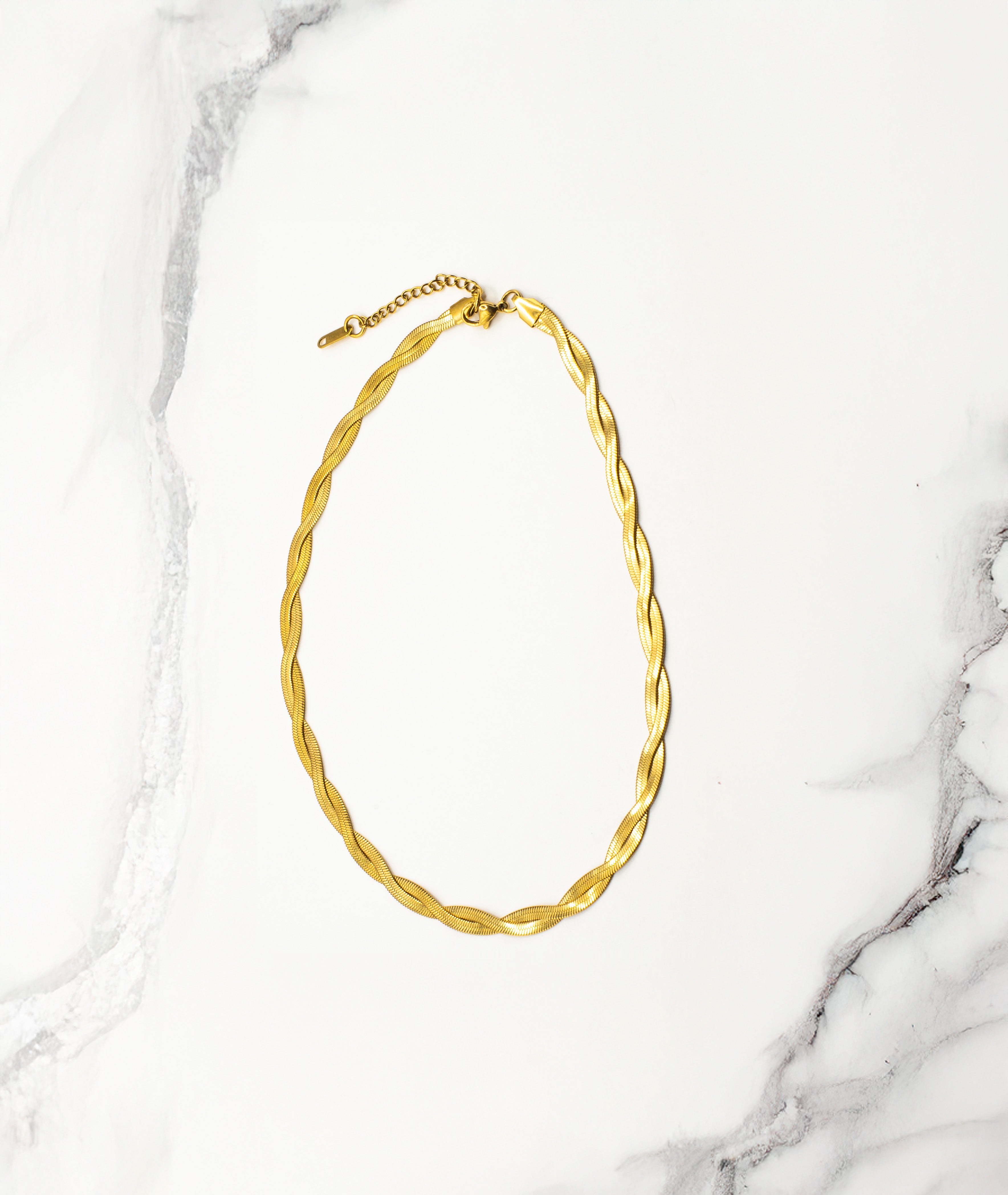 Empress Gold Necklace displayed in a soft curve on a white background, highlighting its radiant 18k real gold finish, 40cm length, and 5cm extension chain.