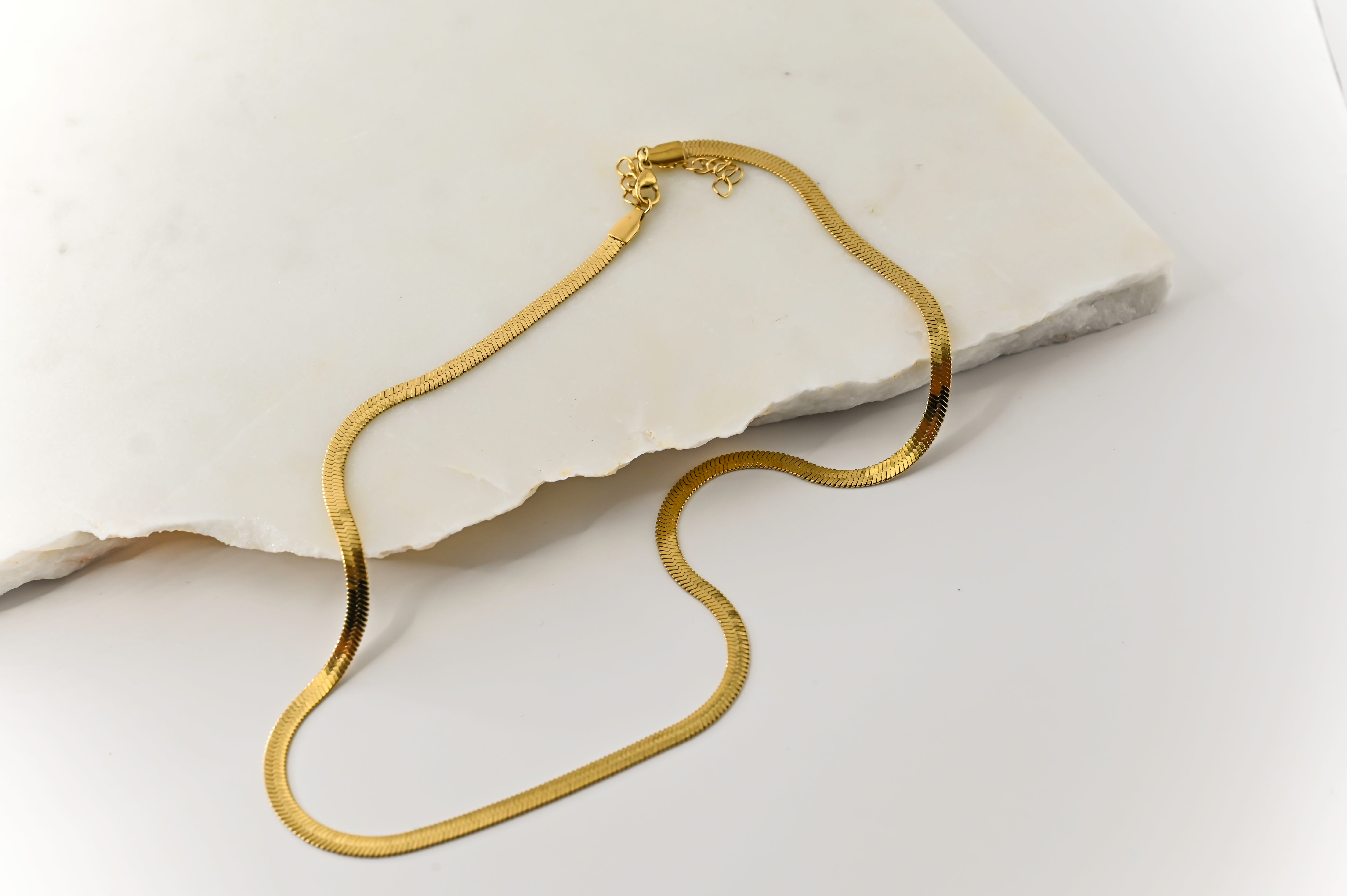 Close-up flat lay 1 of the Cleo Gold Necklace’s clasp, showcasing durable stainless steel craftsmanship and high-quality gold coating.