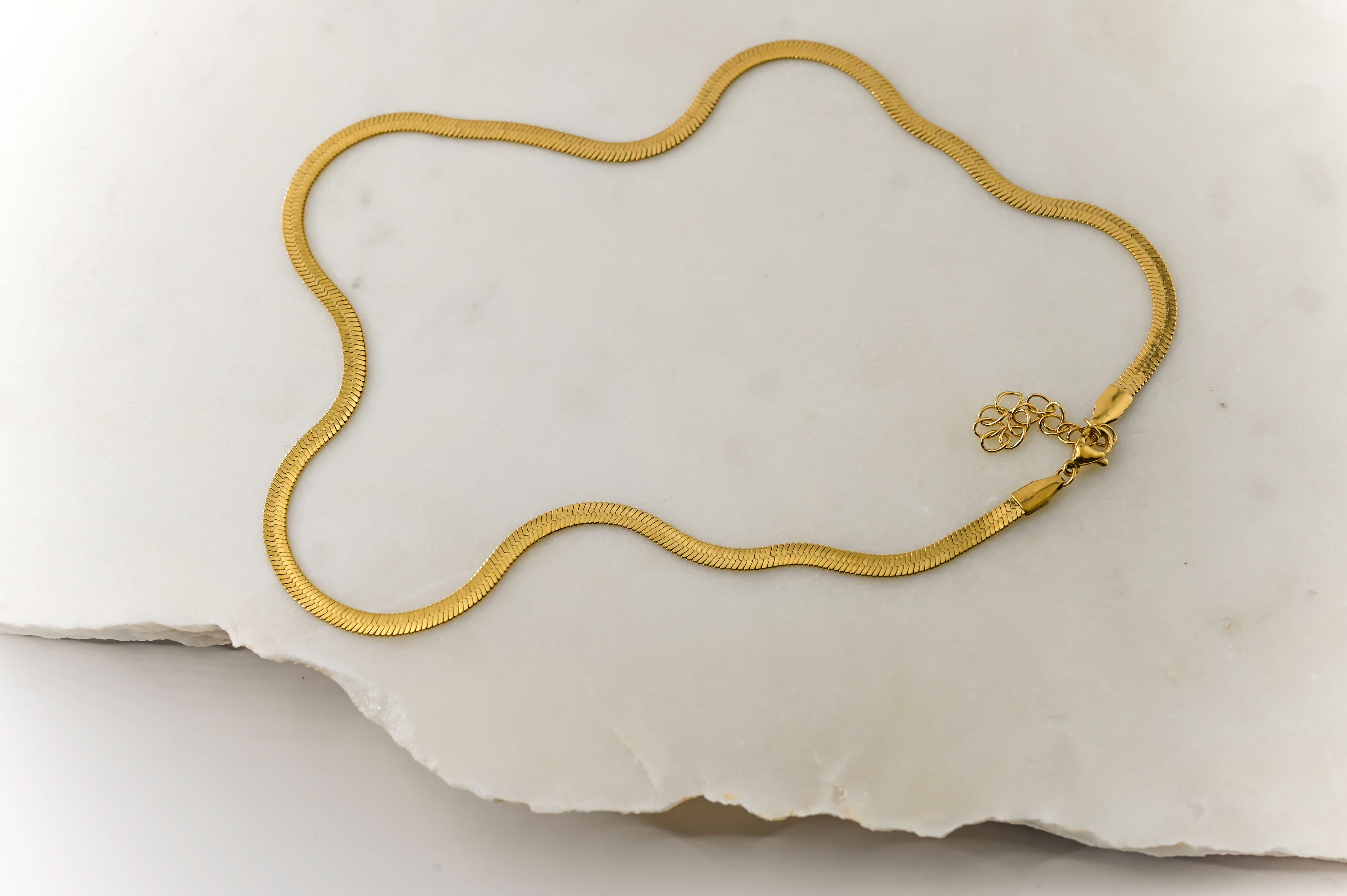 Close-up flat lay 2 of the Cleo Gold Necklace’s clasp, showcasing durable stainless steel craftsmanship and high-quality gold coating.