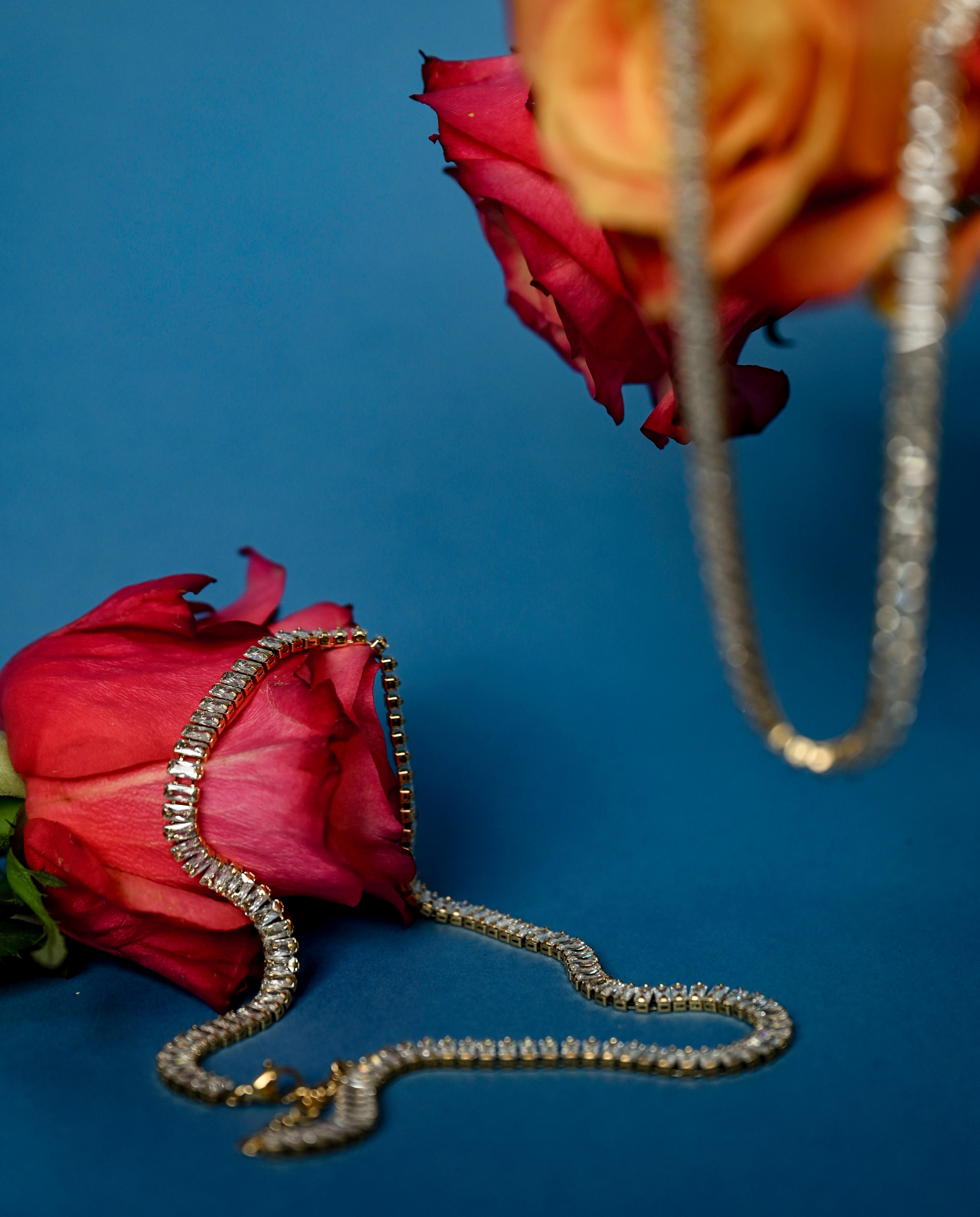 Lustre Gold Necklace styled on soft floral background, emphasizing its gold and crystal elegance against natural textures - Floral image 1