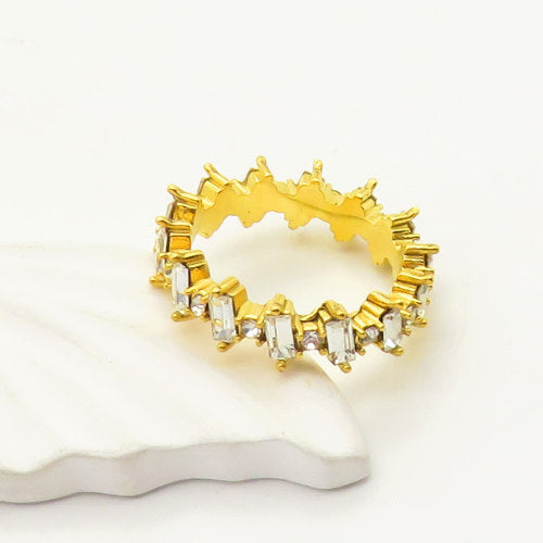 Angled close up view of the Crest Ring featuring brilliant cubic zirconia stones, gold finish, and scratch-resistant stainless steel base.