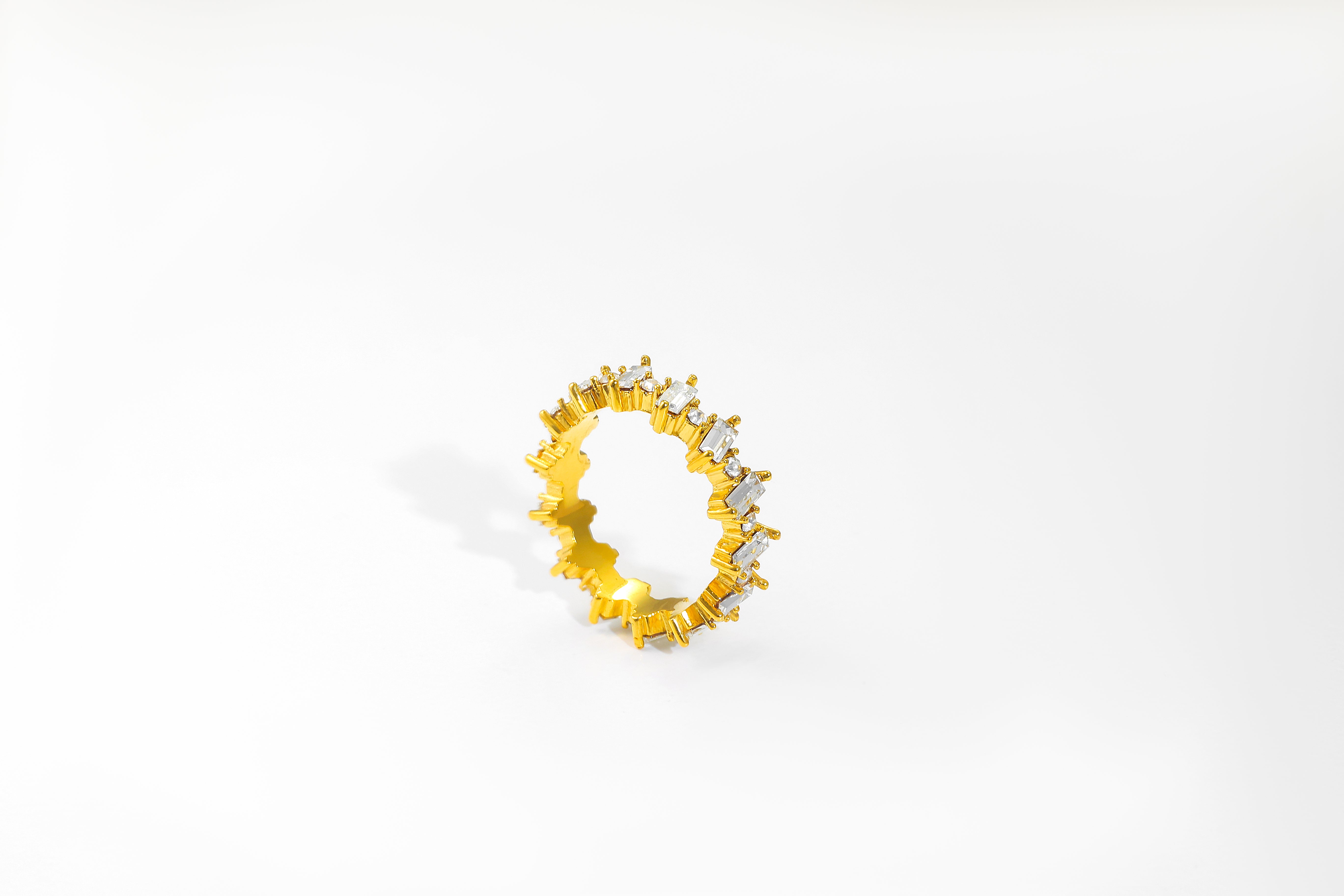 Crest Ring in 18k real gold over stainless steel, with cubic zirconia stones, shown on white background highlighting its polished shine and waterproof build.