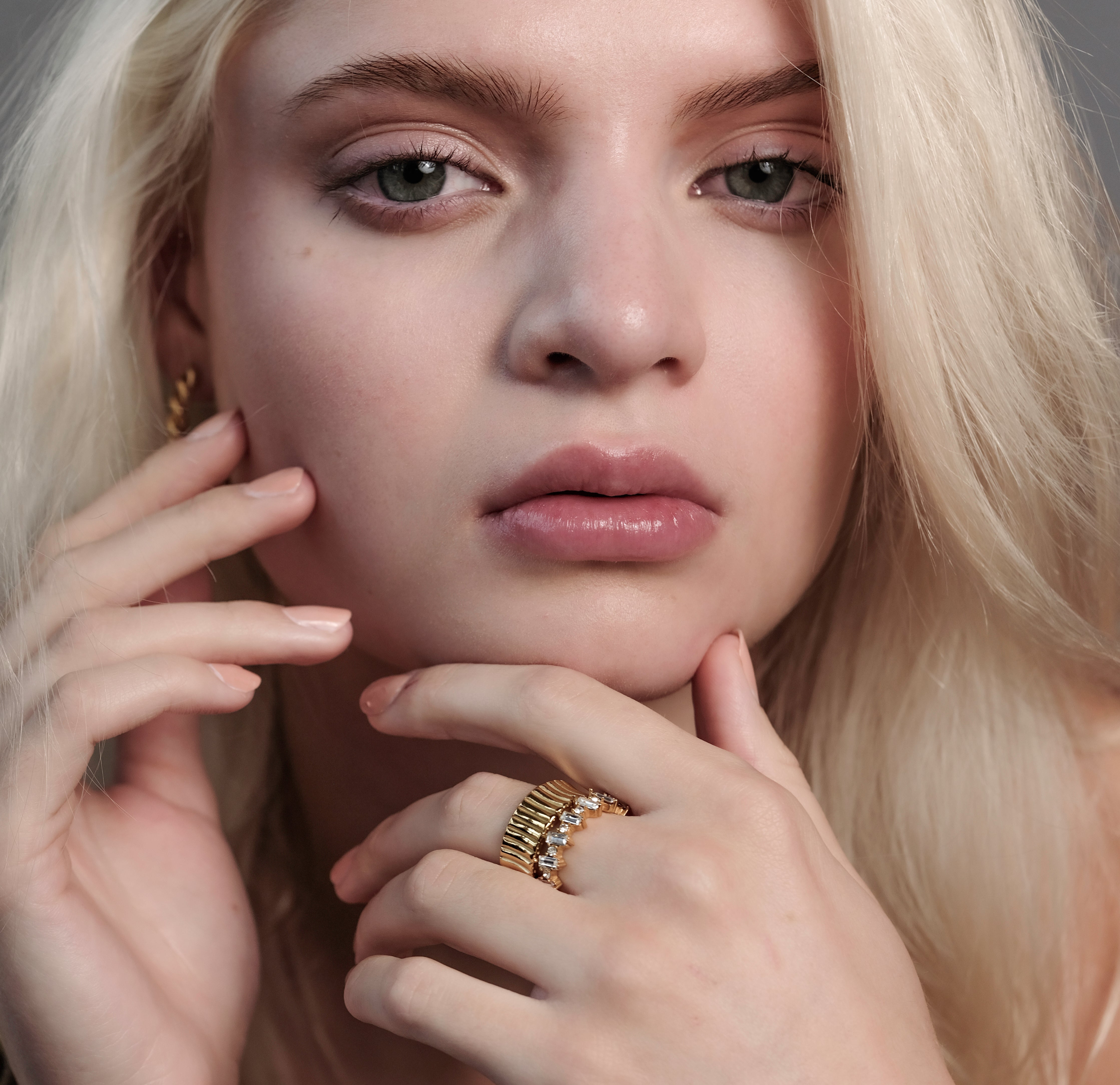Model wearing the Gold Cleo Ring on full hand view, highlighting its gold design and bold presence.