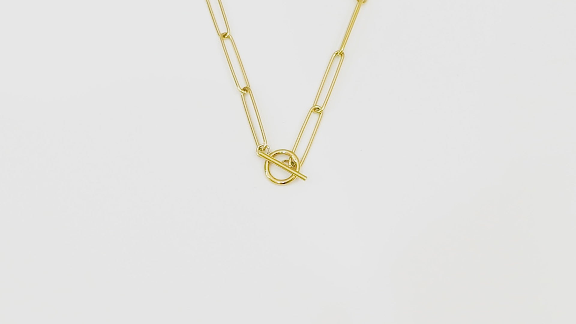 Close-up video of the Unity Chain against a white background, showcasing the 14k real gold design and smooth texture.