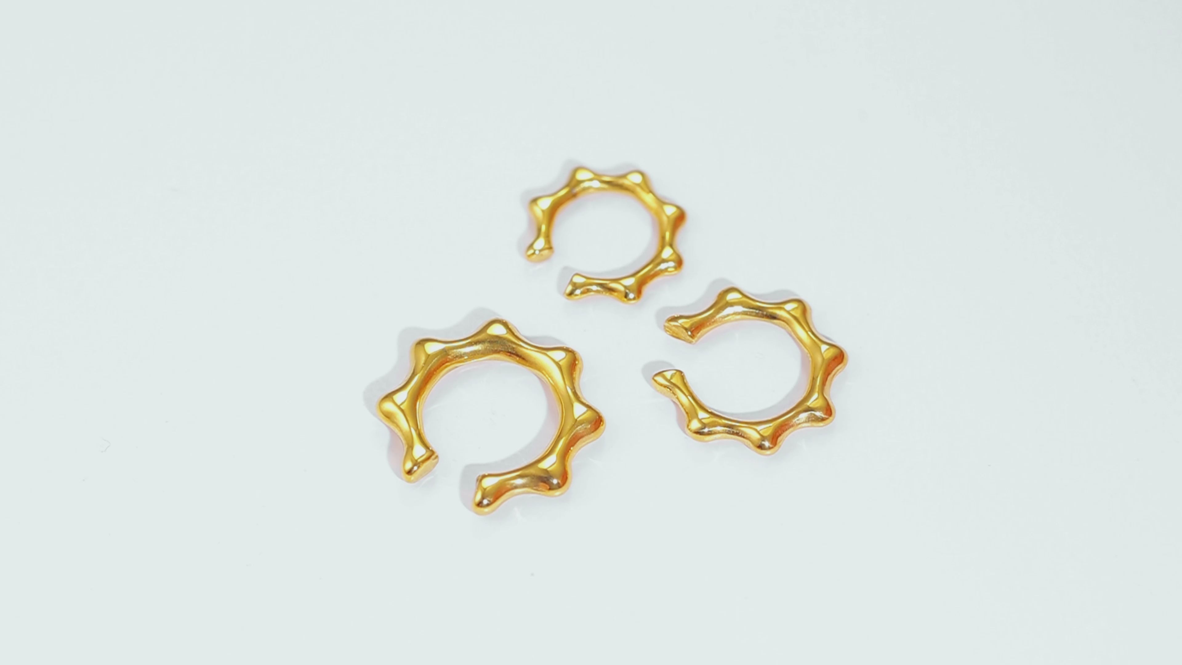 Video of the Gold Crown Earcuffs 3-piece set, rotating to show their varying sizes, smooth 14k gold coating and bold design.