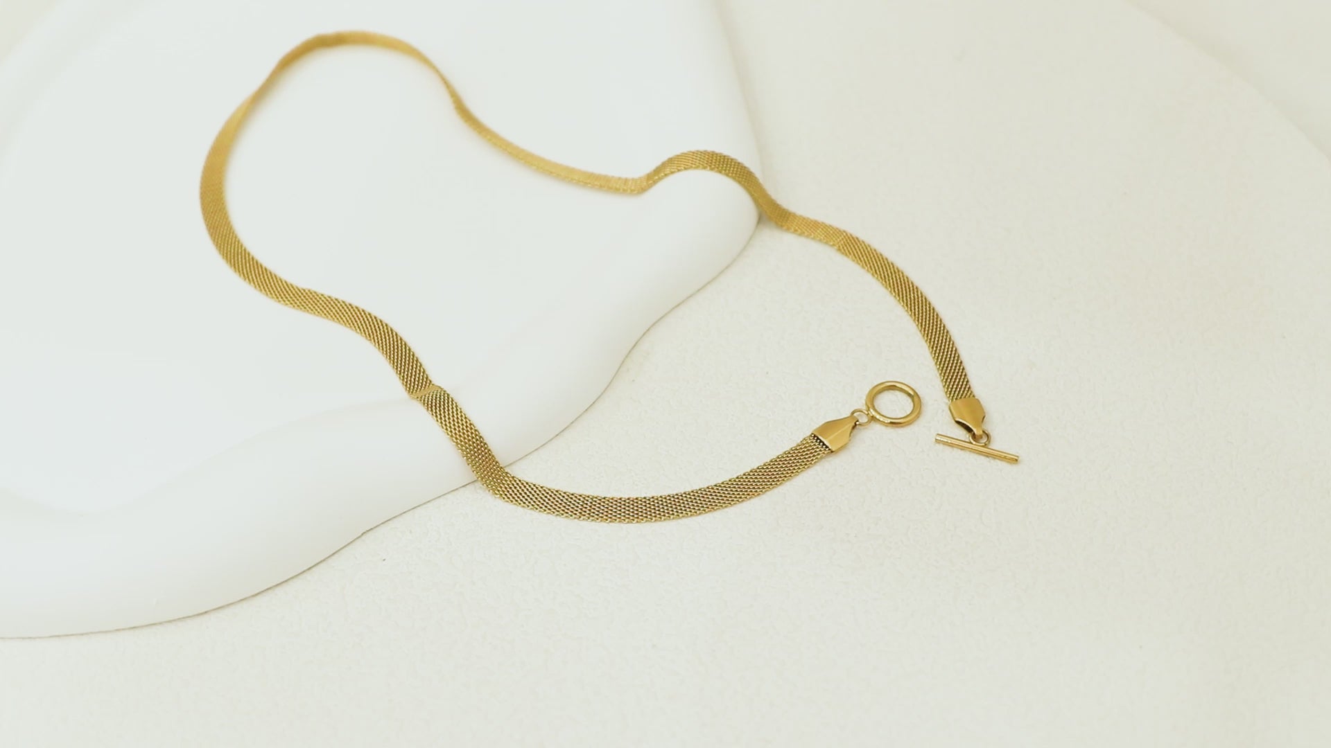 360° rotating video of the Dominion Necklace, highlighting the 14k gold-plated stainless steel links and unique OT closure from all angles.