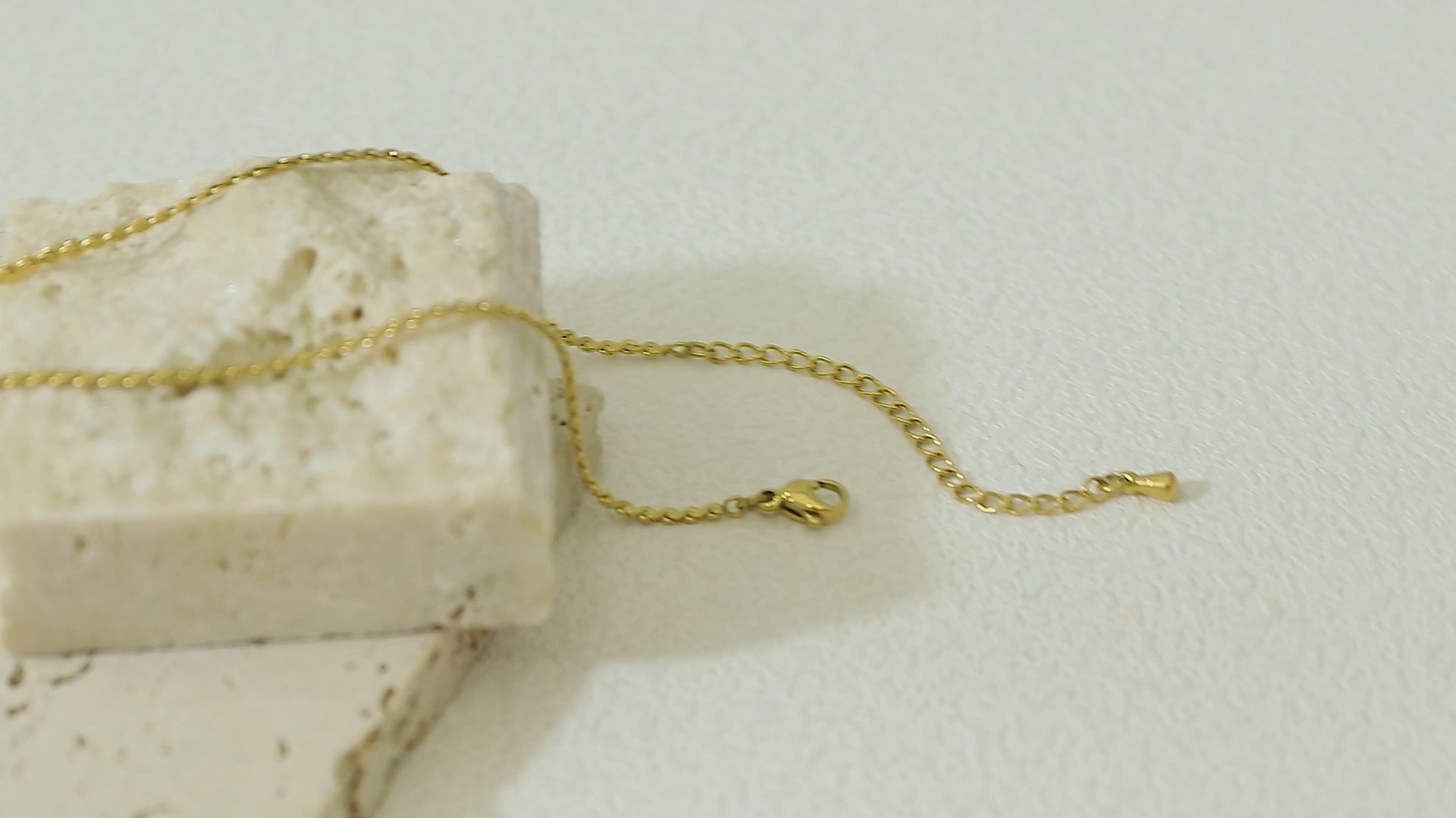 Close-up video of the Allure Chain in motion, focusing on its 14k gold surface, fine link pattern, and waterproof stainless steel core.