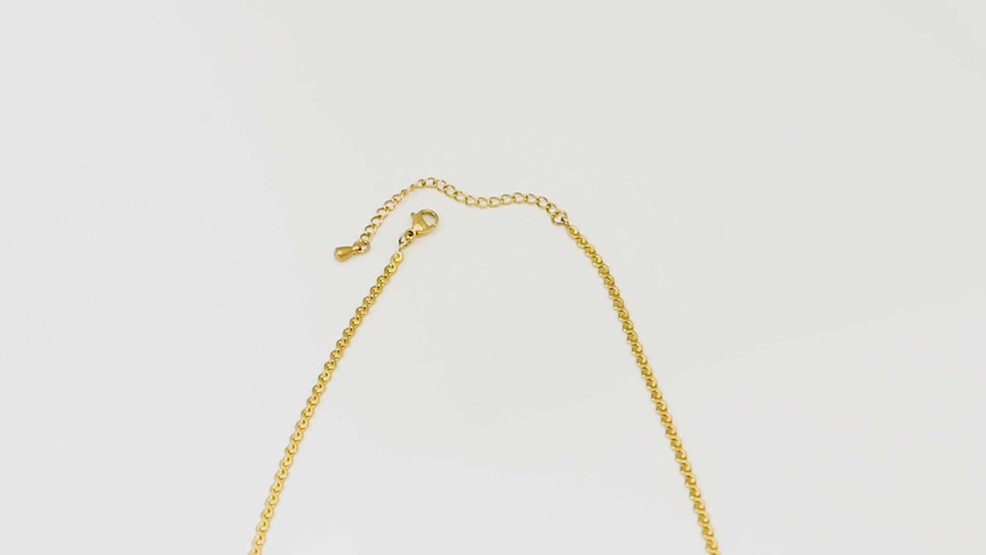 Top-down video panning across the Allure Chain, starting at the clasp, capturing the full length and shimmering 18k gold finish.