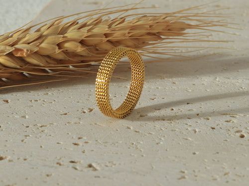 Side view of the Dominion Band in gold, standing upright, showcasing its sleek 18k gold finish and hypoallergenic, scratch-resistant design - Image 1