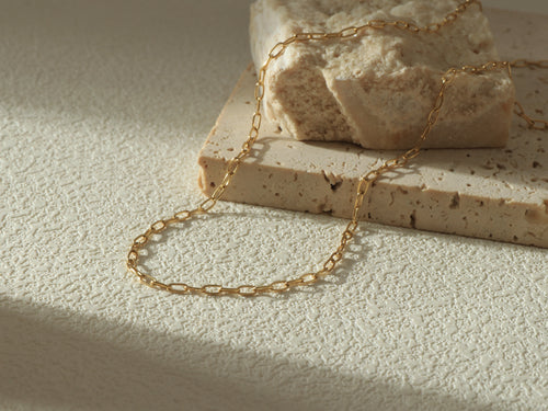 Vivid Chain necklace in 18k gold over stainless steel, bold gold links, waterproof and hypoallergenic - Styled flat lay image 