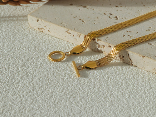 Detailed shot of the Dominion Necklace OT clasp, showcasing its unique, modern design and gold-plated stainless steel construction.
