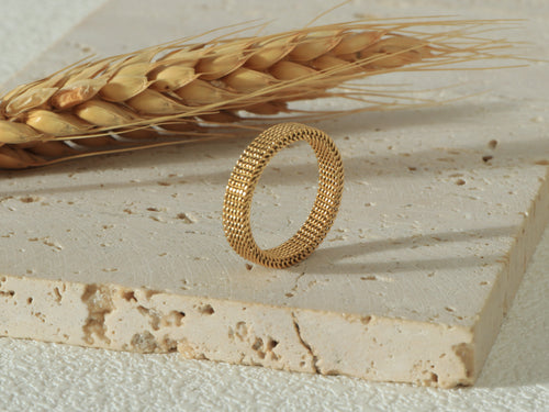 Side view of the Dominion Band in gold, standing upright, showcasing its sleek 18k gold finish and hypoallergenic, scratch-resistant design - Image 2