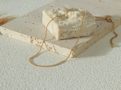 Full flat lay of the Gold Grandeur Chain, including the 5cm extension and OT clasp, highlighting its modern 14k gold finish.