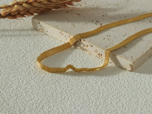 Close-up of the Dominion Necklace links, emphasizing the polished 14k gold finish and scratch-resistant texture.