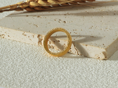 Front view of the Dominion Band in gold, standing tall to display its minimalist design, 18k real gold coating, and stainless steel base.