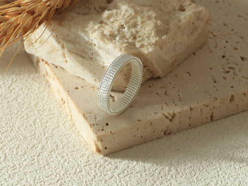 Close-up side view of the Dominion Band in silver, standing on its base, emphasizing the sleek 925 sterling silver coating and minimalist, modern design.