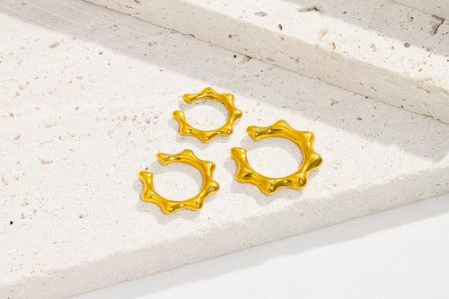 Flat lay of the Gold Crown Earcuffs set - showing all three sizes - waterproof gold earrings that are hypoallergenic 14k gold over stainless steel.