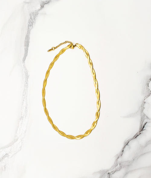 Empress Gold Necklace displayed in a soft curve on a white background, highlighting its radiant 18k real gold finish, 40cm length, and 5cm extension chain.