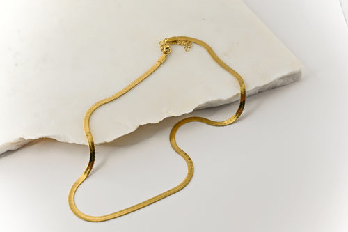 Close-up flat lay 1 of the Cleo Gold Necklace’s clasp, showcasing durable stainless steel craftsmanship and high-quality gold coating.