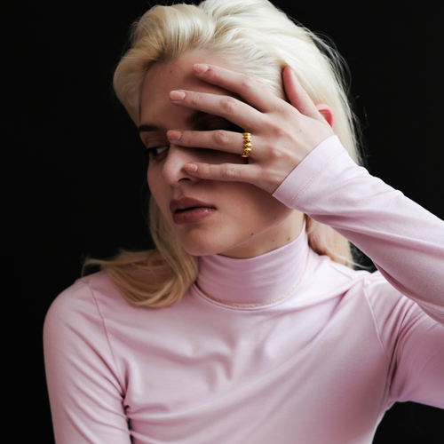 Edgy Gold Ring worn by model, showcasing its bold 18k gold design, smooth surface and fit.