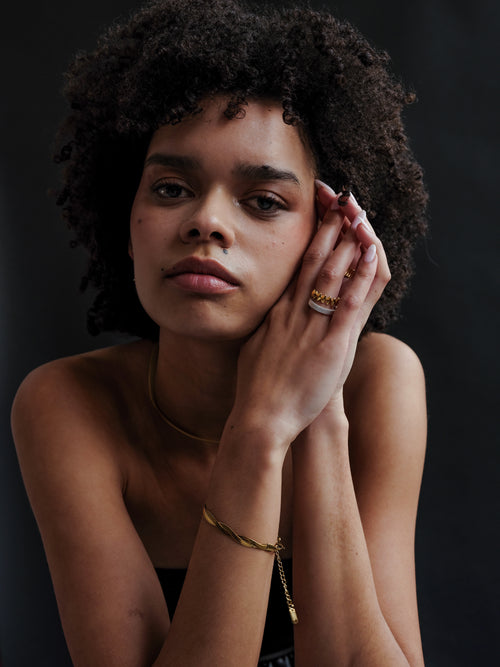 Empress Gold Bracelet worn by model, highlighting its bold, twisted texture, paired with other Divé gold jewellery - Image 2